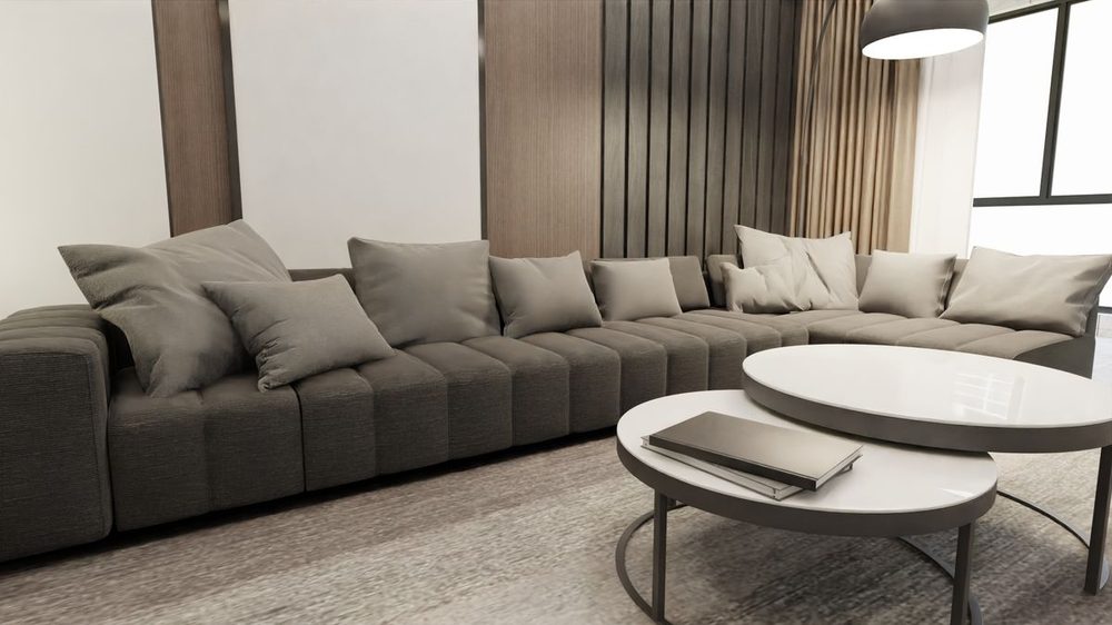 Sillón tapizado en tela gris, limpio y sin manchas, resultado de limpieza profesional de sala en CDMX